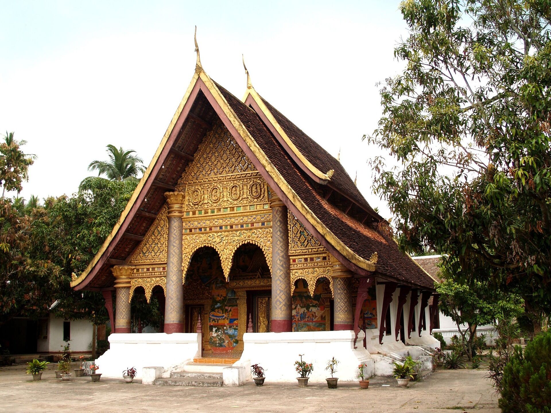 Iconic Luang Prabang temple spires for a vibrant Luang Prabang Travel banner with Legend Travel Group.
